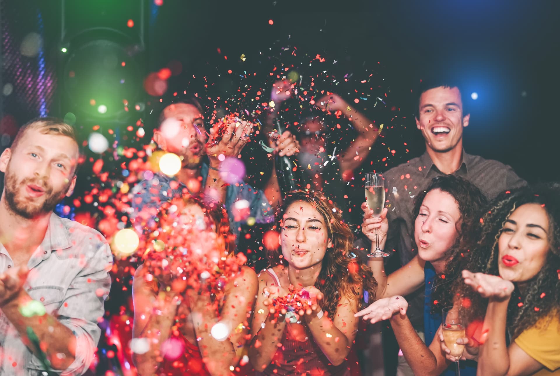 Friends celebrating a birthday together with colourful confetti